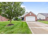 Charming single-story home featuring a brick facade, attached two-car garage, and a well-manicured front lawn at 1605 Leisure Way, Greenfield, IN 46140