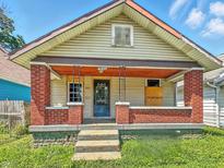 This property features a small front porch with brick columns at 3042 Newton Ave, Indianapolis, IN 46201