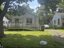 Charming home featuring a cozy front porch and mature shade trees at 3429 Kinnear Ave, Indianapolis, IN 46218
