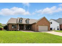 Charming brick home with well-manicured lawn and attached two car garage at 35 Decourcy Ln, Franklin, IN 46131