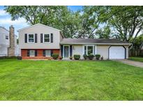 Charming two-story home featuring a well-manicured lawn, classic design, and a cozy, inviting appeal at 3663 Kline N Dr, Indianapolis, IN 46226
