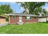 Charming brick single-story home with a well-manicured lawn and a secure front door at 3938 N Grand Ave, Indianapolis, IN 46226