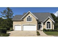 Charming home with a two-car garage and landscaped front yard, offering great curb appeal at 4770 Winterberry Pl, Columbus, IN 47201