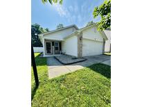 Charming single-Gathering home featuring a well-manicured lawn and a two-car garage at 8323 Lake Tree Ln, Indianapolis, IN 46217
