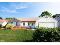 Charming home exterior with brick accent, blue shutters, well-maintained lawn, and inviting curb appeal at 8514 Midsummer Dr, Indianapolis, IN 46239
