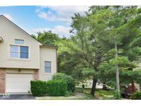 Charming exterior of this home featuring a well-maintained lawn, mature trees, and an attached garage at 9552 Maple Way, Indianapolis, IN 46268