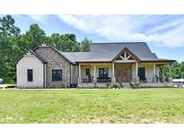 Charming two-story home with a covered porch and beautiful stone and brick accents at 1284 N Letterman Rd, Paragon, IN 46166