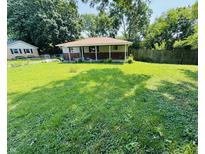 A single story home featuring a spacious front yard with green grass at 1345 S Biltmore Ave, Indianapolis, IN 46241