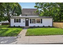 Charming home featuring a well-manicured front lawn and a freshly painted exterior at 1648 Ringgold Ave, Indianapolis, IN 46203