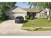 Charming home featuring a two-car garage, well-maintained lawn, and a mix of siding and brick accents at 18 Meadow Creek E Blvd, Whiteland, IN 46184