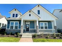 Charming two-story home featuring blue siding, white trim, stone accents, and a welcoming front porch at 19995 Gansett Rd, Westfield, IN 46074