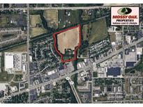 Aerial view of property outlined in red showing home and surrounding land with road and neighborhood at 2000 Hawthorne Dr, Plainfield, IN 46168
