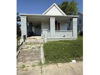 Street view of a single Gathering home, with a covered porch and weathered facade at 2215 Noble St, Anderson, IN 46016