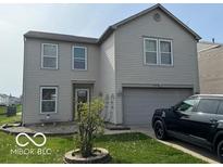Two-story home featuring a large garage, trimmed windows, and a manicured lawn at 2230 Cedarmill Dr, Franklin, IN 46131