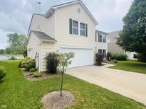 Charming home features a two-car garage, well-maintained lawn, and tasteful landscaping at 2292 Hampton Dr, Franklin, IN 46131