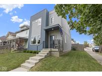 Modern two-story home with blue and gray siding, concrete stairs, and a well-manicured lawn at 2326 Prospect St, Indianapolis, IN 46203