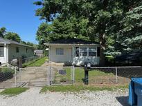 Charming single-story home featuring a fenced front yard and mature trees, perfect for suburban living at 2354 Collier St, Indianapolis, IN 46241