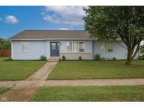 Charming single-story home featuring light blue siding, a well-manicured lawn, and a welcoming front entrance at 3350 Cessna Dr, Columbus, IN 47203