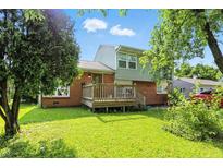 Charming home featuring a brick facade, front deck, and a well-maintained lawn at 4023 N Arlington Ave, Indianapolis, IN 46226