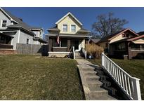 Charming two-story home with a landscaped front yard, American flag, and inviting porch at 429 Wallace Ave, Indianapolis, IN 46201
