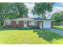 Charming single-story brick home featuring a well-manicured lawn and attached garage at 4625 Beth Ann Dr, Indianapolis, IN 46221