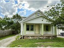 Charming home featuring green trim, covered porch, and beautifully maintained front lawn at 492 S Livingston Ave, Indianapolis, IN 46241