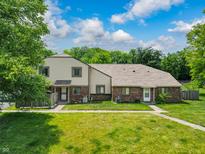 Charming home featuring a lush green lawn and sidewalks leading to inviting entrances at 5965 Deerwood Ct, Indianapolis, IN 46254