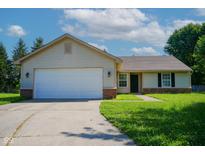 Charming ranch-style home with an attached two-car garage and well-manicured lawn at 6029 Sycamore Forge Dr, Indianapolis, IN 46254