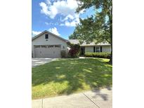Charming single-story home with well-maintained lawn and mature trees on a sunny day at 8425 Brook Pointe Ct, Indianapolis, IN 46234