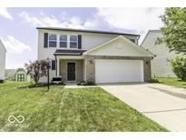 Charming two-story home featuring a two-car garage, well-maintained lawn and tidy landscaping at 9665 Gull Lake Dr, Indianapolis, IN 46239