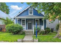 Charming blue home with white trim, front porch, and well-maintained landscaping at 1151 S Randolph St, Indianapolis, IN 46203