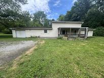 Charming two-story home with a covered porch, attached garage, and a spacious front yard at 1330 Schleicher Ave, Indianapolis, IN 46229