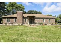 Charming brick home featuring a well-manicured lawn and inviting front entrance at 1346 N Buck Creek Rd, Greenfield, IN 46140