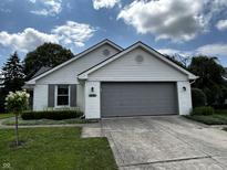 Charming home featuring a well-maintained lawn and a neutral-colored garage door, providing a welcoming curb appeal at 2083 Kerns Ct, Carmel, IN 46280