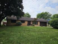 Charming single-story brick home featuring a well-maintained lawn and an attached garage at 2239 Chevelle Ct, Anderson, IN 46012