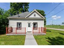 Charming one-story home with a red porch, a well-maintained lawn, and classic architectural details at 2702 S Moreland Ave, Indianapolis, IN 46241