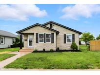 Charming single-story home boasting a stone facade, black trim, and well-manicured lawn at 2715 S A St, Elwood, IN 46036