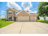 Charming brick home featuring a three-car garage, well-maintained lawn, and inviting curb appeal at 296 Myers Lake Dr, Noblesville, IN 46062
