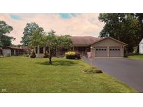 Charming single-story ranch home with a well-manicured lawn and attached two-car garage at 3422 Sycamore Dr, Columbus, IN 47203