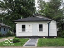 Charming renovated bungalow with white siding, contrasting trim and a well-manicured lawn at 3455 Brouse Ave, Indianapolis, IN 46218