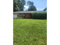 Traditional single-story home with a brick facade, green lawn, and mature landscaping at 3535 Parrish Ct, Indianapolis, IN 46227