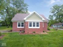 Charming brick home featuring a gabled roof, trimmed windows and a well manicured front lawn at 4219 Mathews Ave, Indianapolis, IN 46227