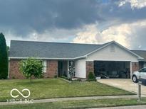 Charming brick ranch-style home featuring an attached two-car garage and well-maintained lawn at 6334 Winslow Dr, Indianapolis, IN 46237