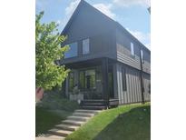 Contemporary two-story home with a well-manicured lawn and concrete steps leading to the covered front porch at 955 Dorman St, Indianapolis, IN 46202