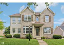 Charming two-story brick home with a well-manicured lawn, symmetrical design, and decorative shutters at 1246 Valdosta Pl, Westfield, IN 46074