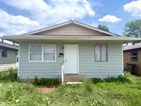 Charming single-story home featuring a well-maintained exterior, front door, and landscaped front yard at 1509 S Rural St, Indianapolis, IN 46203