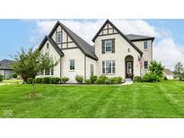 Stunning two-story home featuring a manicured lawn, black trim, and a welcoming entrance at 16283 Spring Bank Ct, Fishers, IN 46040