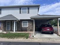 Charming two-story home with carport, landscaped yard, and brick accents at 2080 Miracle Dr, Columbus, IN 47201