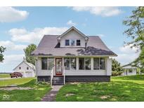 Charming two-story home featuring a red front door and large windows, perfect for natural light at 26735 Six Points Rd, Sheridan, IN 46069