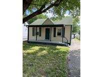 Charming single-story home featuring a covered front porch, green shutters, and a well-maintained lawn at 3059 5Th E Ave, Indianapolis, IN 46221